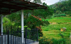 a porch of a house with a view of a field at Ella River Breeze Homestay in Ella