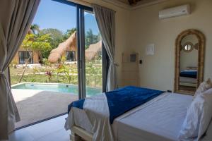 a bedroom with a bed and a swimming pool at Corales de Isla Fuerte in Puerto Limón