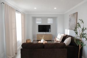 a living room with a couch and a flat screen tv at Modern Condo Near Wright-Patt Shops & Dining in Beavercreek