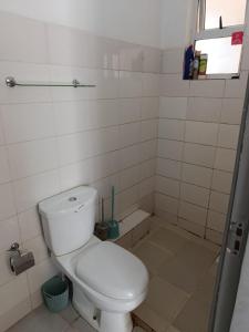 a small bathroom with a toilet and a window at Nyumbani in Nairobi