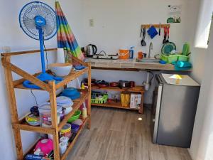 a kitchen with a sink and a counter with a fan at Casa la xulada in Mazunte