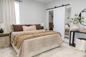 a bedroom with a large bed and a mirror at Modern Condo Near Wright-Patt Shops & Dining in Beavercreek
