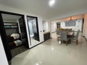 a living room with a table and a dining room at Hospedaje La Patrona in Chignahuapan