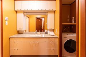 a bathroom with a sink and a washing machine at HP Jōshin in Nagoya +16 photos
