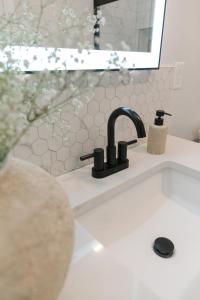 a bathroom sink with a faucet and a mirror at Modern Condo Near Wright-Patt Shops & Dining in Beavercreek +28 photos