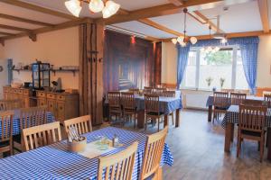 a restaurant with tables and chairs in a room at Hotel Stangl in Hamm +6 photos