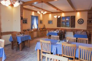 a restaurant with blue and white tables and chairs at Hotel Stangl in Hamm