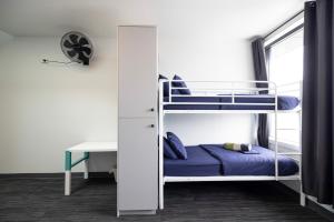 a room with two bunk beds and a desk at Spinners Hostel in Perth +12 photos