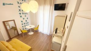 a living room with a couch and a table at Hotel Nizza Creative Hotel in Rimini