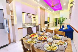 a table with plates of food on it in a room at Amara Lux Rivage wynad in Vythiri