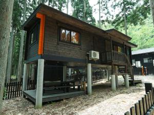 a tree house in the woods with a basketball hoop at Japanese Cottage Nagomiya seseragi in Gujo