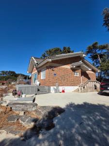 a brick house with a driveway in front of it at Mooldan Dongsan Taean in Taean