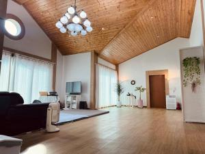 a living room with a couch and a chandelier at Mooldan Dongsan Taean in Taean