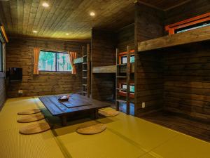 a room with a wooden table in a log cabin at Japanese Cottage Nagomiya seseragi in Gujo