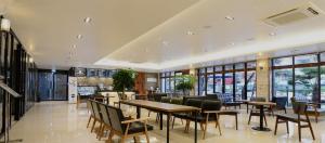 a restaurant with tables and chairs in a building at Tourist Hotel Sacheon in Sacheon