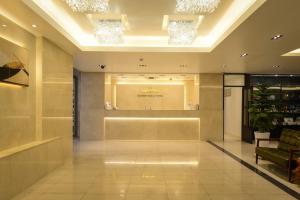 a lobby with a waiting area in a building at Tourist Hotel Sacheon in Sacheon