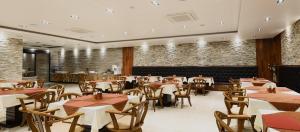 a restaurant with tables and chairs in a room at Tourist Hotel Sacheon in Sacheon