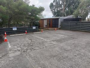 a building with orange cones in a parking lot at Rural in the city in Palmerston North