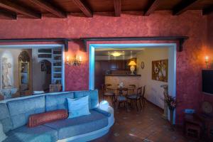 a living room with a blue couch and a table at Nido Paraiso in Santa Úrsula