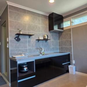 a kitchen with a sink and a counter at Gangneung Moan Pension in Gangneung +11 photos