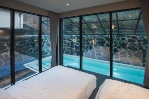 a bedroom with a view of a swimming pool at Chaeonjae Gongju in Gongju