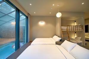 a bedroom with two beds and a bunk bed at Chaeonjae Gongju in Gongju
