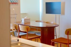 a small table and chairs in a room at Busan Neouigyejeol in Busan +28 photos
