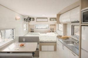an rv with a kitchen and a dining area with aamine at Yeosu Si-in Place Pension in Yeosu