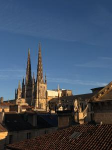 a large cathedral with two spires in a city at Cocon dans le centre in Bordeaux