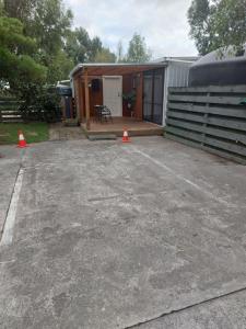 a parking lot with orange cones in front of a house at Rural in the city in Palmerston North