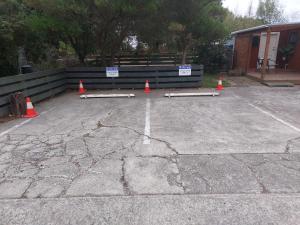 a parking lot with orange cones and signs on it at Rural in the city in Palmerston North +29 photos