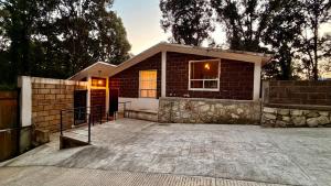 a small brick house with a patio at Villa 2 Senderó del Bosque in Omitlán de Juárez