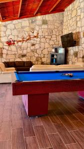a pool table in a room with a stone wall at Villa 2 Senderó del Bosque in Omitlán de Juárez +18 photos