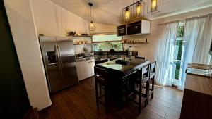 a kitchen with a stainless steel refrigerator and a counter at Villa 2 Senderó del Bosque in Omitlán de Juárez