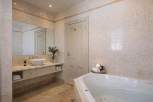 a large bathroom with a tub and a sink at Grande Vue Hotel in Hobart +75 photos