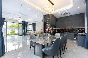 a kitchen and dining room with a table and chairs at Villa B2-34 Long Cung in Vung Tau