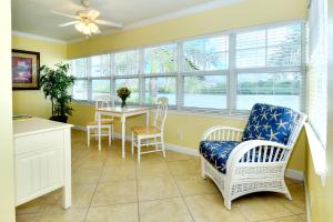 a dining room with a table and chairs and windows at Barefoot Beach Resort in Clearwater Beach