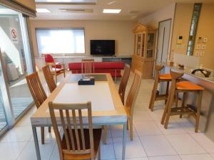 a kitchen and dining room with a table and chairs at Takayama Fortune-inn in Takayama