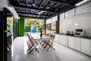 a kitchen with a table and chairs in a room at Villa B2-10 Long Cung in Vung Tau
