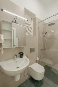 a bathroom with a sink and a toilet and a shower at Mulberry Living in Negombo +35 photos