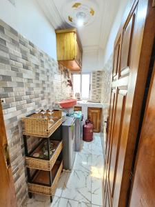 a kitchen with a counter with baskets on the floor at FOKOU House in Yaoundé