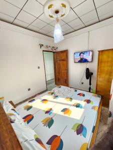 a bedroom with a large bed with colorful umbrellas at FOKOU House in Yaoundé