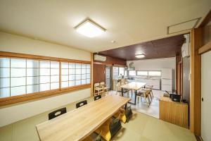 a kitchen and dining room with a table and chairs at Yuen in Beppu