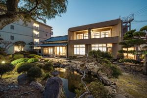 a building with a garden in front of it at Yuen in Beppu