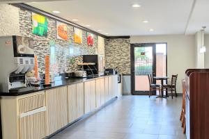 a restaurant kitchen with a counter and a table at Quality Inn DFW Airport North in Irving