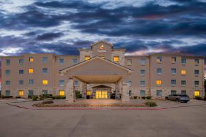 a large building with a parking lot in front of it at Comfort Suites San Antonio North - Stone Oak in San Antonio