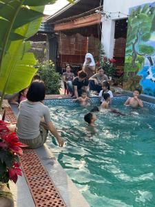a group of people sitting in a swimming pool at Flora Garden Homestay in Xuân Sơn +6 photos
