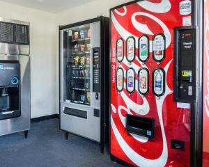 a coca cola vending machine next to a refrigerator at Econo Lodge Lawrence near University in Lawrence