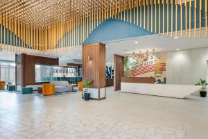 a lobby of a hotel with a chandelier at Cambria Hotel Nashville Midtown in Nashville