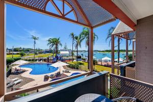 a view of the pool from the balcony of a resort at Comfort Resort Waters Edge in Port Macquarie